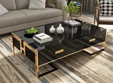 Table basse design laqué noir et pieds acier effet or miroir Raluxe 130 cm