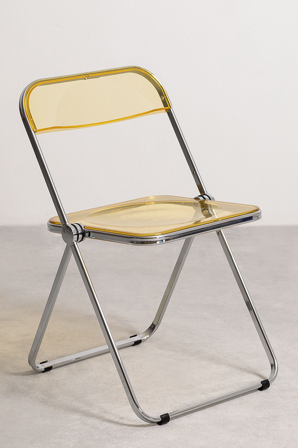 Chaise pliante métal chromé et polycarbonate jaune transparent